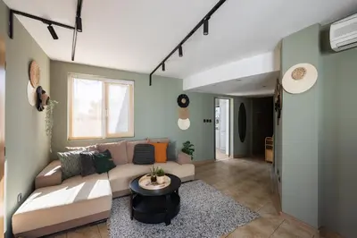 a living room with a couch and a table at Promenade Rooftop Flat in Varna City