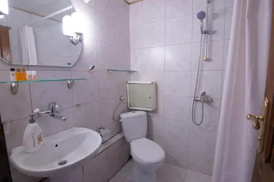 a bathroom with a toilet and a sink and a shower at One-bedroom Flat Close to the Sea Garden by Flat Mаnаger in Burgas City