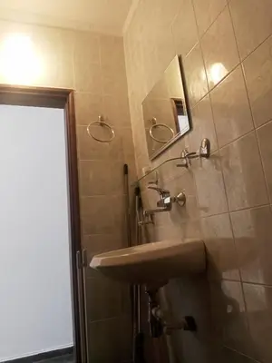 a bathroom with a sink and a mirror at Апартамент Браво in Sunny Beach