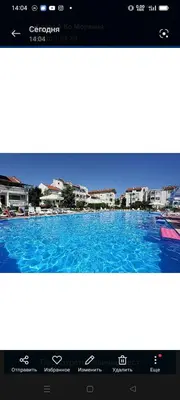 a picture of a swimming pool with buildings in the background at Апартамент Браво in Sunny Beach