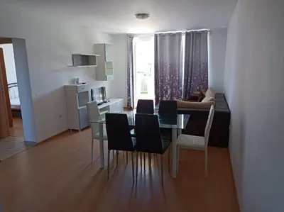a dining room and living room with a table and chairs at Sozopoli Hills, app B7 in Sozopol