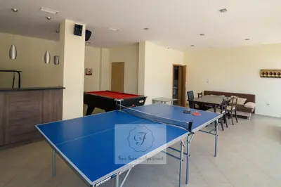 a ping pong table in the middle of a room at BohoTide by the Sea in Bliznatsi