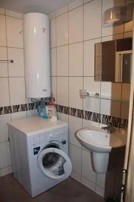 a small bathroom with a washing machine and a sink at Vilmar Studio in Pomorie