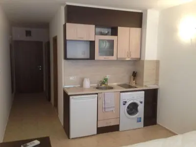 a small kitchen with a washing machine and a washer at Vilmar Studio in Pomorie