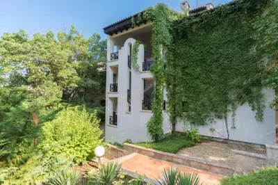 a house with ivy on the side of it at Oasis Resort & Spa Cozy Studio in Lozenets