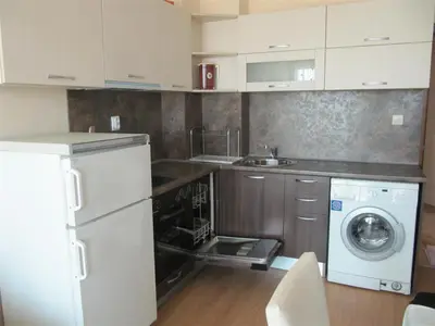 a kitchen with a washing machine and a washer at Rayski zalez in Pomorie