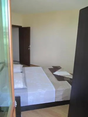 a bedroom with two beds with white sheets at Rayski zalez in Pomorie