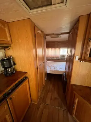 an interior view of a small kitchen with a bed at Каравана Чайка in Sozopol