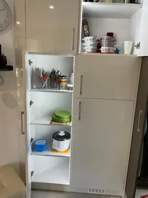 a white refrigerator with its door open with dishes at Horizon Apartament Gut in Sveti Vlas