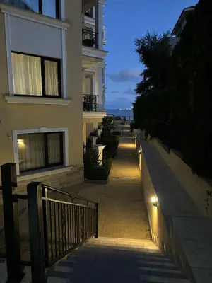 a sidewalk with lights in front of a building at Horizon Apartament Gut in Sveti Vlas