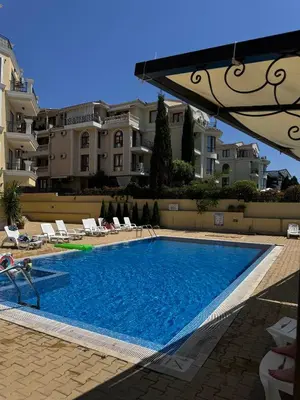 a swimming pool in front of some apartment buildings at Horizon Apartament Gut in Sveti Vlas