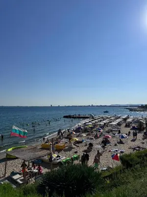 a beach with a lot of people in the water at Horizon Apartament Gut in Sveti Vlas