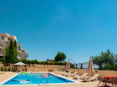 a swimming pool with lounge chairs and a swimming pool at Horizon Apartament Gut in Sveti Vlas