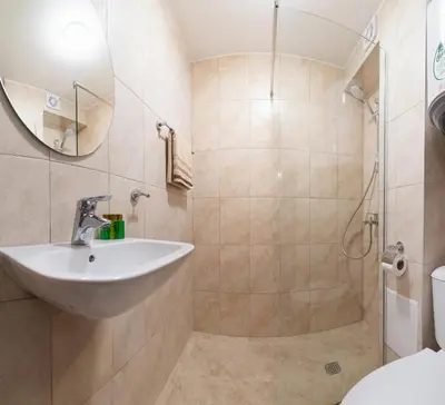 a bathroom with a sink and a shower at Deluxe and Central Garden Apartment in Varna City