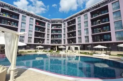 a large building with a swimming pool in front of it at Апартамент в Рейнбоу 3 in Sunny Beach