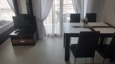 a dining room with a table and chairs and a window at Апартамент в Рейнбоу 3 in Sunny Beach