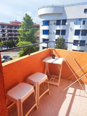 a balcony with two tables and chairs on a building at Fa Mol in Sunny Beach