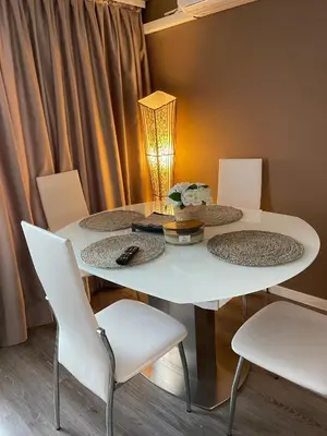 a white table with four chairs and a lamp at My Sweet Home in Burgas City