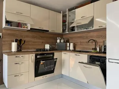 a kitchen with white cabinets and a sink at My Sweet Home in Burgas City