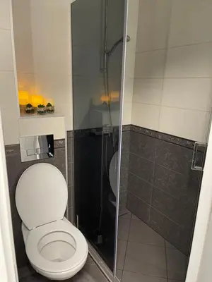 a bathroom with a toilet and a shower at My Sweet Home in Burgas City