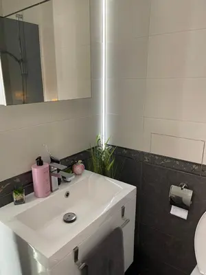 a bathroom with a white sink and a mirror at My Sweet Home in Burgas City