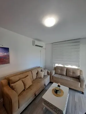 a living room with a couch and a coffee table at Апартамент Ели in Obzor