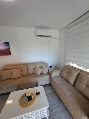 a living room with a couch and a coffee table at Апартамент Ели in Obzor