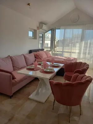 a living room with a couch and a table with chairs at Perla 2 studio in Burgas City