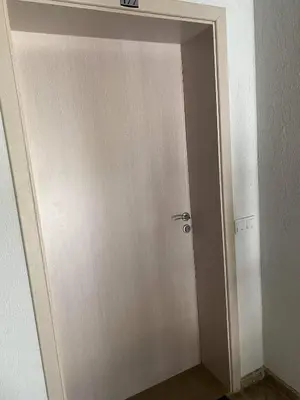 a white door with a silver handle in a room at Luxory Apartament on the Seaside, Gradina beach, St Nicholas Complex in Chernomorets