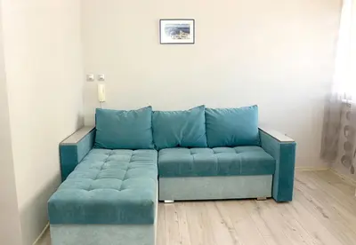 a blue couch sitting in a living room at ~ The Blue ~ 1BD Flat near Asparuhovo Sea Garden in Varna City