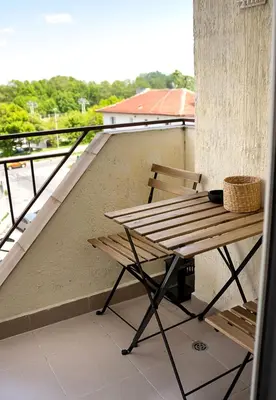 a table and bench on a balcony with a view at ~ The Blue ~ 1BD Flat near Asparuhovo Sea Garden in Varna City