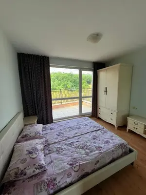 a bedroom with a bed and a large window at Nieli-1 SP apartments in Byala