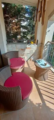a patio with two tables and chairs and a table at Green Life Private apartments in Sozopol