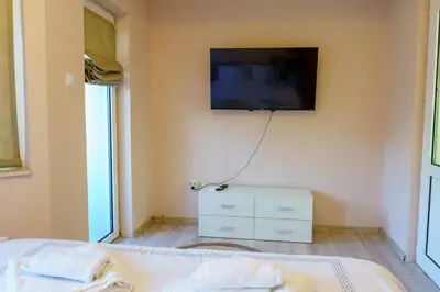 a bedroom with a flat screen tv on the wall at Centrally Located Apartment in Varna in Varna City