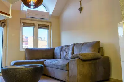 a living room with a couch and a window at Centrally Located Apartment in Varna in Varna City