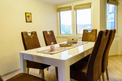 a dining room with a table with a laptop on it at Centrally Located Apartment in Varna in Varna City