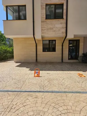 an orange sign sitting in front of a building at Апартамент ИВАНОВИ Сарафово in Burgas City