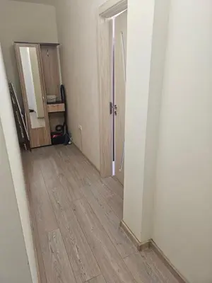 an empty hallway with a mirror and a wooden floor at Апартамент ИВАНОВИ Сарафово in Burgas City