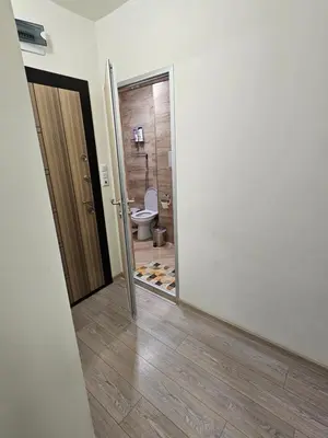 a bathroom with a door leading to a toilet at Апартамент ИВАНОВИ Сарафово in Burgas City