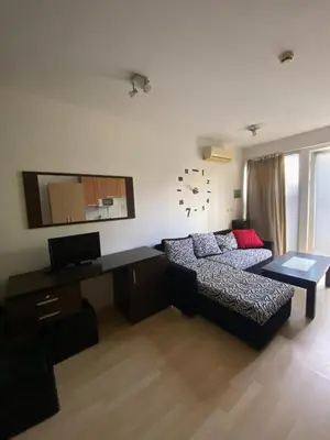 a living room with a bed and a desk at Stella Polaris 1 Apartments in Sunny Beach