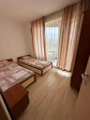 a small room with two beds and a window at Stella Polaris 1 Apartments in Sunny Beach