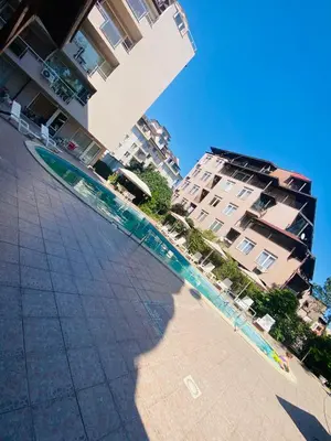 a large swimming pool next to a tall building at Stella Polaris 1 Apartments in Sunny Beach
