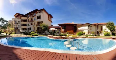 a swimming pool in front of a building at Къща на брега на морето Свети Влас, Garden of Eden in Sveti Vlas