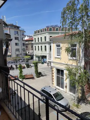 a balcony with a car parked on a street at ALEKS Top Center in Burgas City