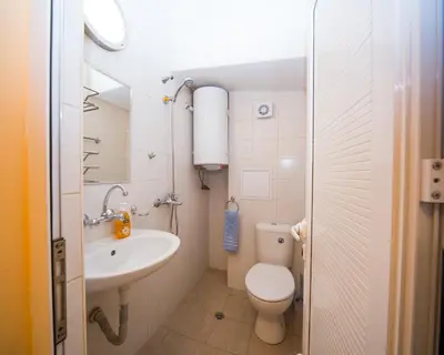 a small bathroom with a toilet and a sink at ALEKS Top Center in Burgas City