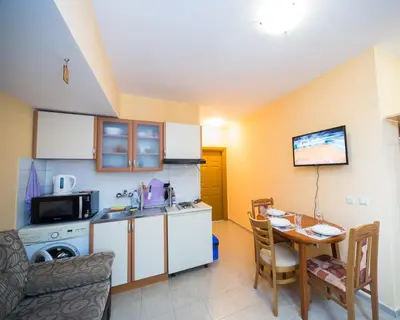 a small kitchen with a table and a dining room at ALEKS Top Center in Burgas City
