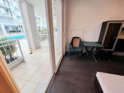 a room with a table and a chair and a balcony at Sunny Dream Apartments Sunny Beach Bulgarien Sonnenstrand in Sunny Beach