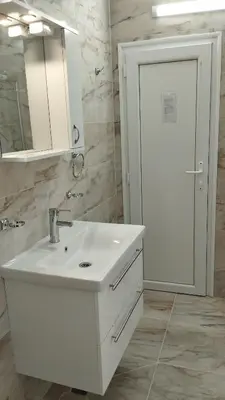 a white bathroom with a sink and a mirror at Valemar Apartments in Pomorie