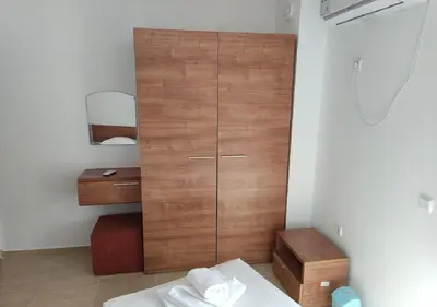 a bedroom with a wooden cabinet in a room at Ideal three bed apartment for families closed to the Beach in Sunny Beach