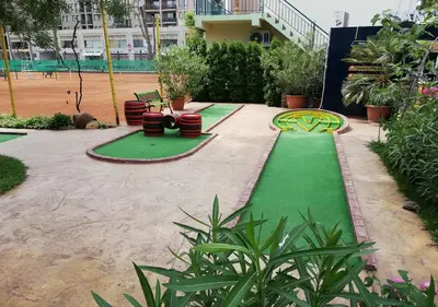 a playground with a green lawn and a play court at Ideal three bed apartment for families closed to the Beach in Sunny Beach